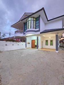 a large white house with a large driveway at Warni Villa 197 Whole Or Room in Muar