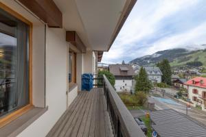 a balcony with a view of a city at Appartement au centre de megève in Megève
