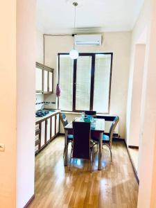 a kitchen and dining room with a table and chairs at Central apartments in Kutaisi