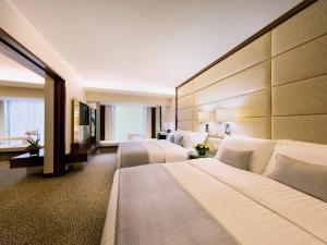 Postel nebo postele na pokoji v ubytování Regal Kowloon Hotel
