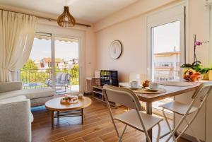 a kitchen and living room with a table and chairs at K&E Guesthouse in Preveza