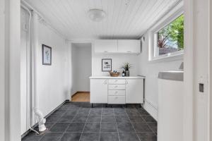 a kitchen with a counter and a sink and a window at Basement Apartment -Ås Ski in Ås