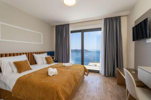 a bedroom with a large bed with a large window at Green Horizon Sea Views Villa in Dubrovnik +20 photos