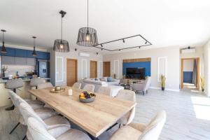 a dining room and living room with a table and chairs at Green Horizon Sea Views Villa in Dubrovnik