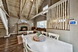 a dining room with a table and a fireplace at CYH0876 - Island Cabin cabin in South Lake Tahoe
