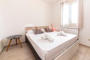ein weißes Schlafzimmer mit einem Bett und einem Fenster in der Unterkunft Oasi delle Meraviglie in Torre dell'Orso
