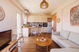a living room with a couch and a table at K&E Guesthouse in Preveza +12 photos