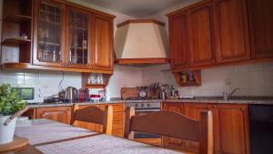 a kitchen with wooden cabinets and a stove top oven at Casa di Alice in Angera +11 photos