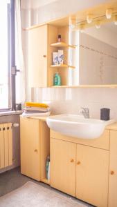 a bathroom with a sink and a mirror at Casa di Alice in Angera