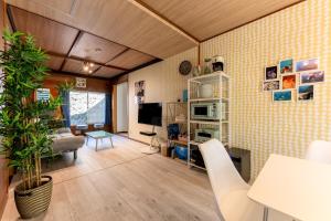 a living room with a couch and a table at AZUR 伊豆富戸 sirene in Ito