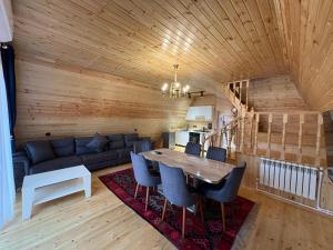 a living room with a table and a couch at ART Otel in Qusar