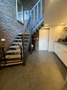 a hallway with a staircase and a brick wall at By Balu in Soest