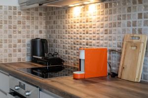 a kitchen counter with an orange box on a counter top at Seaside Escape in Kalamata +35 photos