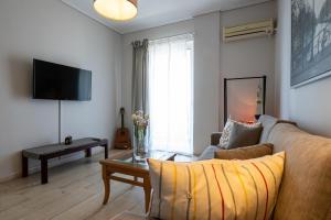 a living room with a couch and a table at Seaside Escape in Kalamata