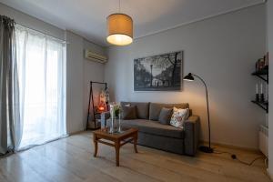 a living room with a couch and a table at Seaside Escape in Kalamata