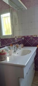 een badkamer met een witte wastafel en een spiegel bij Maison Gorges du Gardon in Collias +10 foto's