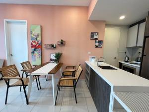 a kitchen with a table and chairs and a counter at The Robertson Bukit Bintang by Wowhome in Kuala Lumpur