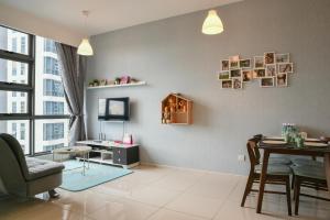 a living room with a table and a dining room at The Robertson Bukit Bintang by Wowhome in Kuala Lumpur