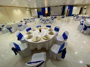 a banquet hall with a table and chairs in a room at Curv Hotels minutes to Airport- Malls in Puerto Princesa City