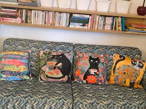 a couch with four pillows with cats on it at Liège centre 6 rue montagne sainte Walburge, 4000 Liège, pour 2 pers à 3 minutes de la gare st Lambert in Liège