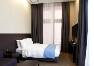 A bed or beds in a room at S Stay Hotel Dongtan