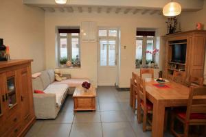 a living room with a couch and a table at Vives les vacances 4 Ch in Arques-la-Bataille