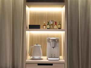 a cupboard with a coffee maker and a blender at Hotel Villa Fontaine Grand Tokyo-Roppongi in Tokyo +51 photos