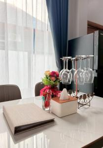 a table with wine glasses and a box on it at Krabi Mantra Pool Villa in Ao Nang 