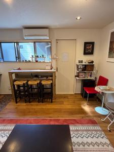 a living room with a table and chairs at Kanazawa Guesthouse Stella in Kanazawa