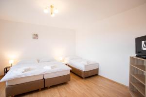 Posteľ alebo postele v izbe v ubytovaní Amenity Apartmány Perná