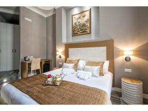 a bedroom with a large bed with a tray of food on it at Lea Luxury Rooms in Rome