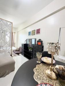 a room with a bed and a table and a couch at Maiko Happy Studio near US Embassy in Manila