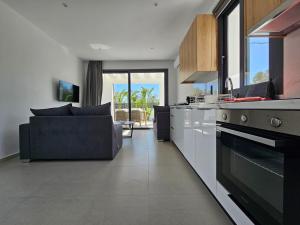 a kitchen and living room with a couch at Myrteni Pool Villas in Ialysos