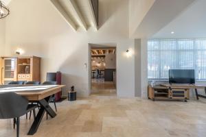 an office with a table and chairs and a dining room at La Longère de l'Éolienne - Clim, billard & jardin in Billy