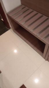 a room with two bunk beds with white tile floors at Hotel Garden View - Mansarovar in Jaipur