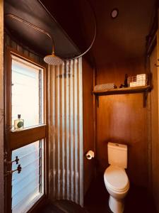 a bathroom with a toilet and a window at B Farm in Bobs Farm