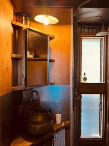 a kitchen with a sink and a mirror at B Farm in Bobs Farm