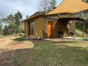 a small house with a porch and a door at Racons del Pedraforca in Saldés