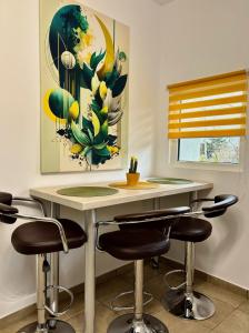 a kitchen with a table with chairs and a painting at Casa SOFI Nr 1, Breaza PH in Breaza