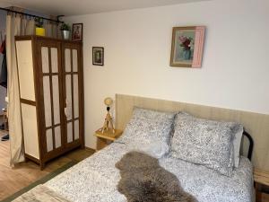 a bedroom with a bed with a dog laying on it at Chambre pour 2 personnes, forêt, piscine in Arbonne-la-Foret