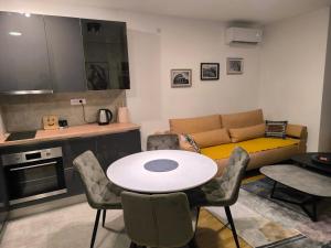 a living room with a table and a couch at COMODO "Green Hill" in Soko Banja