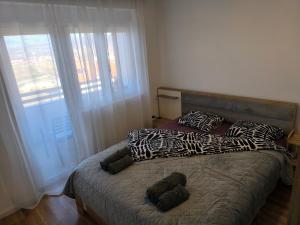 a bed with stuffed animals on it in a bedroom at COMODO "Green Hill" in Soko Banja