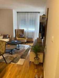 a living room with a couch and a table at COMODO "Green Hill" in Soko Banja