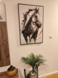 a painting of a horse hanging on a wall at COMODO "Green Hill" in Soko Banja