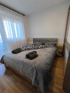 a bed with pillows on it in a bedroom at COMODO "Green Hill" in Soko Banja