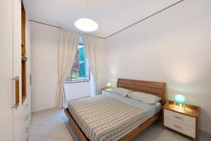a bedroom with a bed and a window at La Finestra sul Mare in Genoa