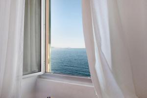 a window with a view of the ocean at La Finestra sul Mare in Genoa