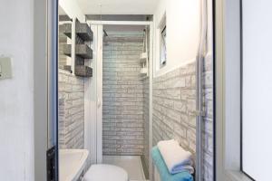 a bathroom with a toilet and a glass shower at La Finestra sul Mare in Genoa