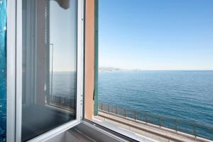 a view of the ocean from a window at La Finestra sul Mare in Genoa