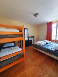 a bedroom with two bunk beds and a mirror at Manoir Le Castel & Villa Beaumaris in Saint Malo